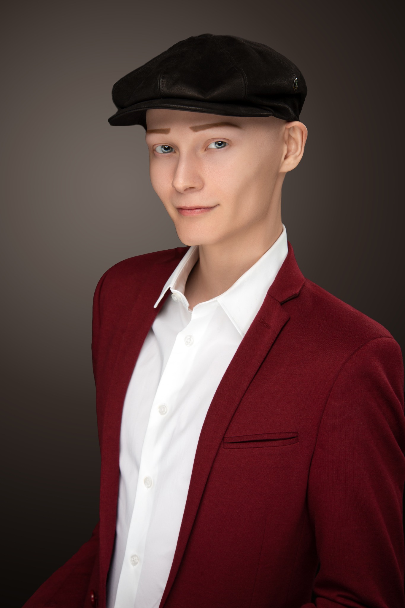 JJ Gray wearing a burgundy jacket and black cap